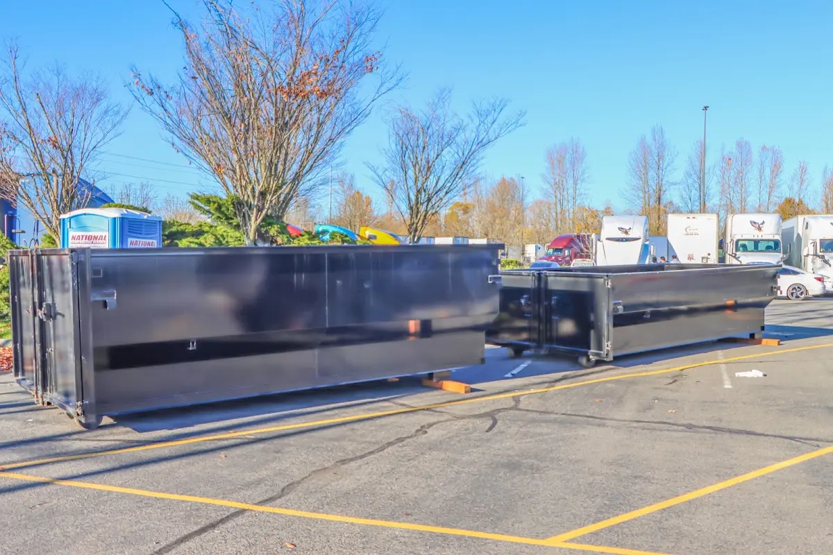 Professional dumpster rental service with roll-off container on residential driveway in Silver Springs
